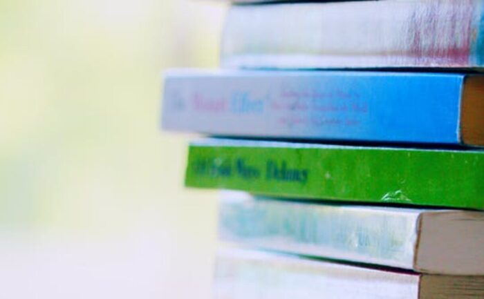selective focus photo of pile of assorted title books
